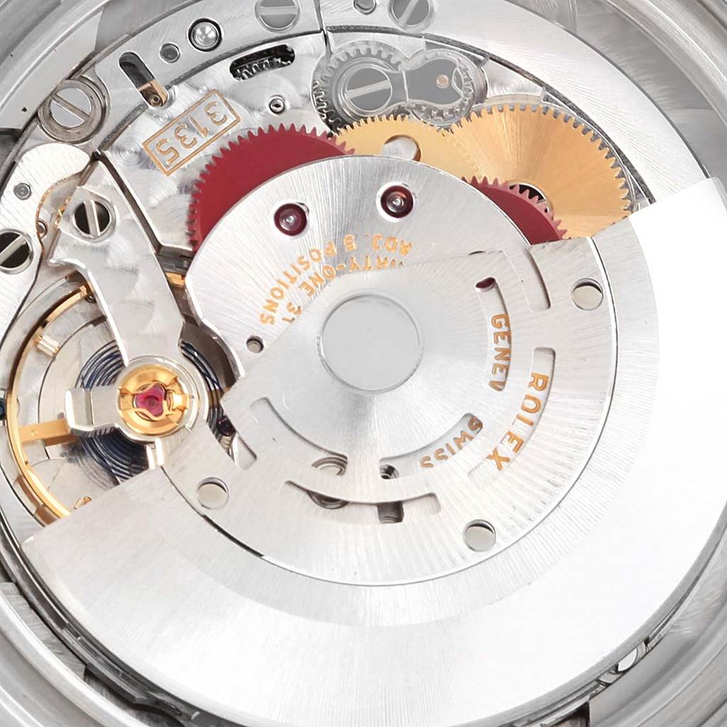 This image shows an up-close view of the internal mechanism of a Rolex Submariner 116619 Men's White Gold Blue Dial 116619 Men's White Gold Blue Dial watch, focusing on its intricate gears and components.