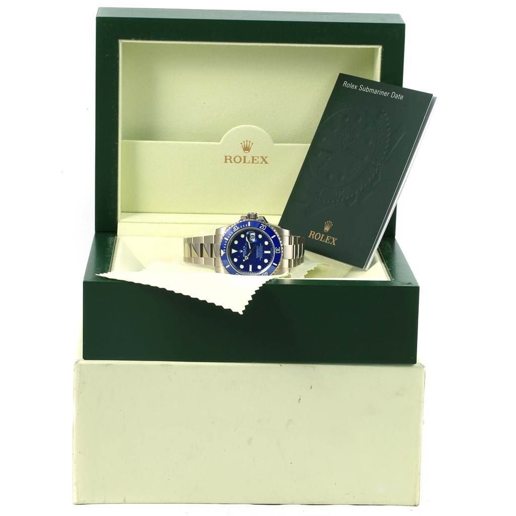 The Rolex Submariner 116619 Men's White Gold Blue Dial 116619 Men's White Gold Blue Dial watch is displayed front-on in its green box, accompanied by the Rolex manual.