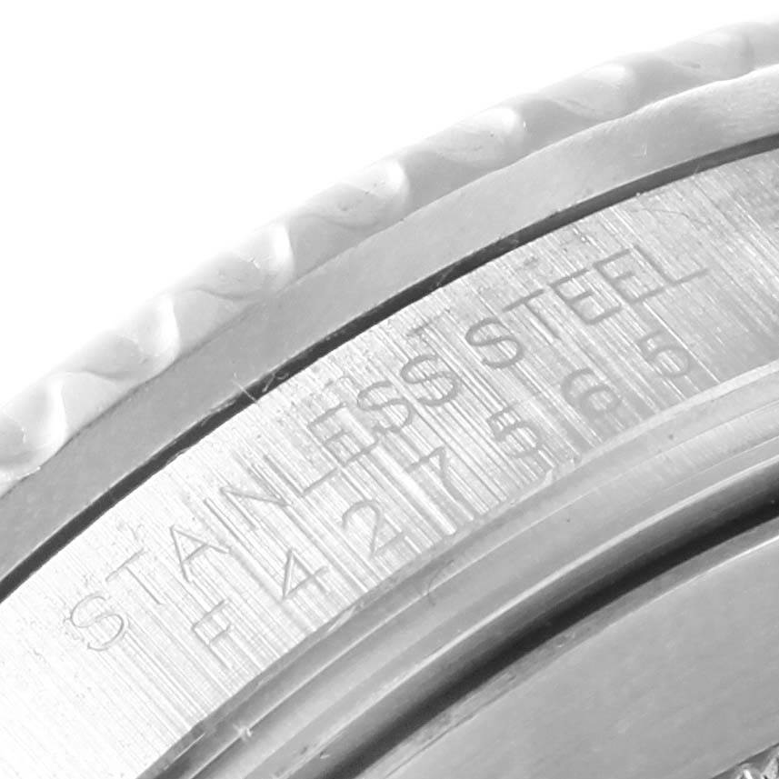 This close-up image shows the edge and inner side of the bezel of a Rolex Submariner 16610LV Men's Stainless Steel Black Dial 16610LV Men's Stainless Steel Black Dial watch, with "STAINLESS STEEL" engraved.