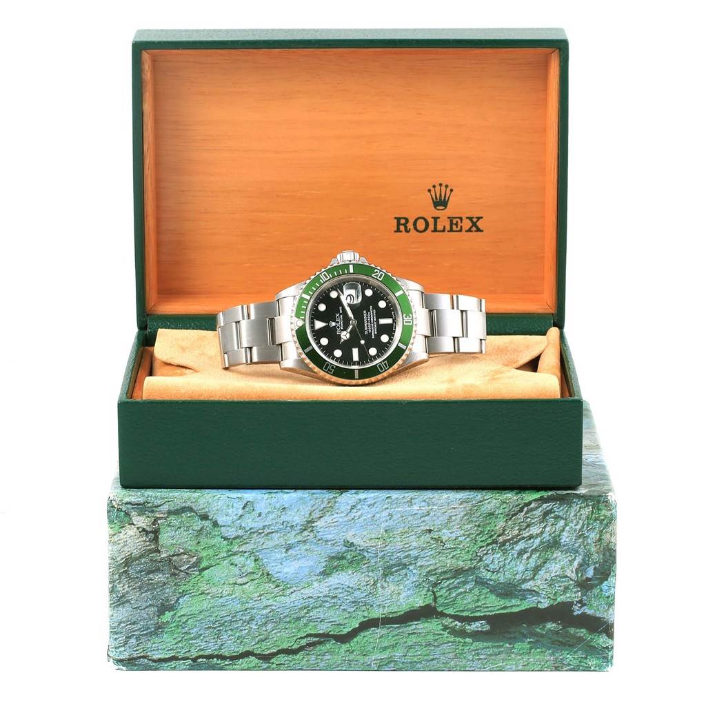 This Rolex Submariner 16610LV Men's Stainless Steel Black Dial 16610LV Men's Stainless Steel Black Dial watch is displayed front-facing in its open green and wooden box.