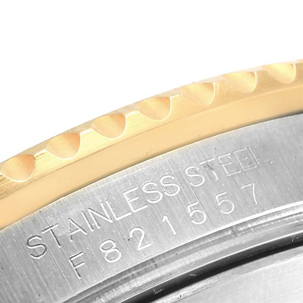 This image shows a close-up of the bezel and part of the case back of a Rolex Submariner 16613 Men's Steel and Gold (two tone) Blue Dial 16613 Men's Steel and Gold (two tone) Blue Dial watch.
