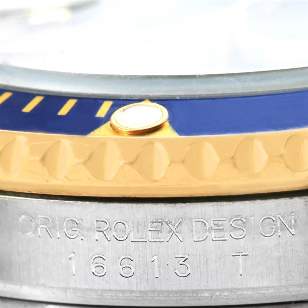 Close-up view of the bezel and side engraving on a Rolex Submariner 16613 Men's Steel and Gold (two tone) Blue Dial 16613 Men's Steel and Gold (two tone) Blue Dial model.