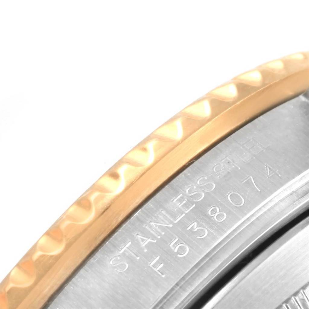 Close-up of the Rolex Submariner 16613 Men's Steel and Gold (two tone) Blue Dial 16613 Men's Steel and Gold (two tone) Blue Dial watch showing part of the stainless steel and gold bezel with an engraved serial number.