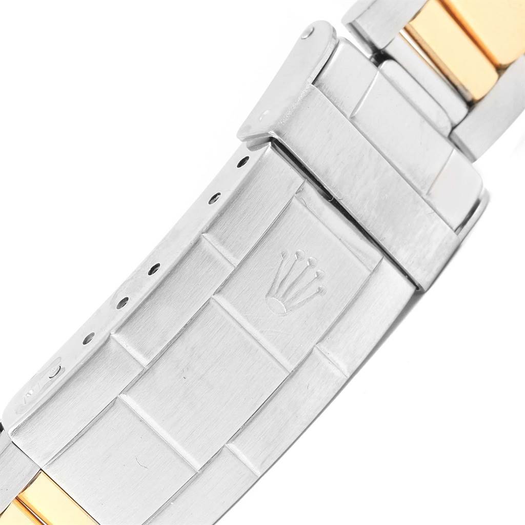 This image shows the clasp and part of the bracelet of a Rolex Submariner 16803 Men's Steel and Gold (two tone) Black Dial 16803 Men's Steel and Gold (two tone) Black Dial, showcasing the company's logo.