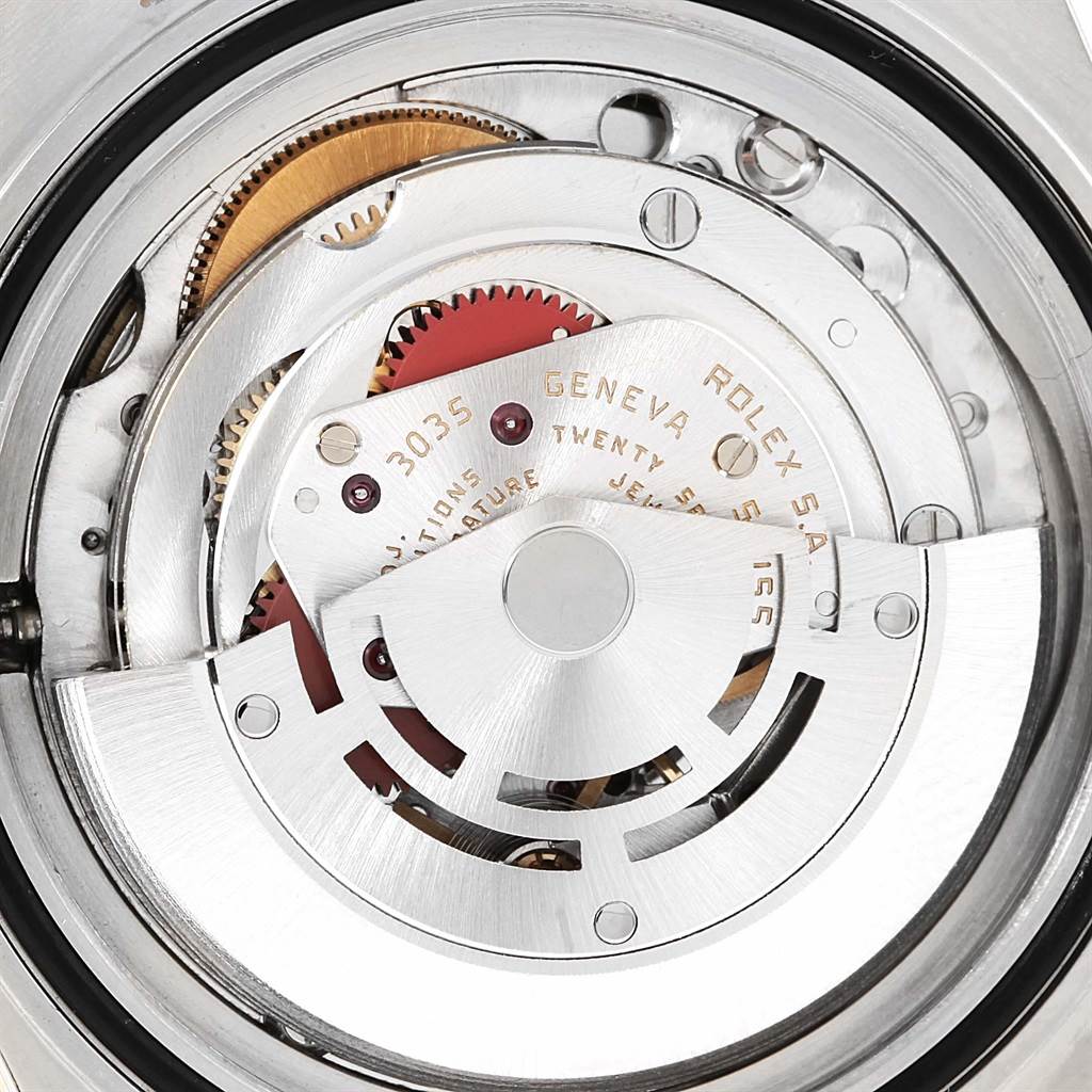 This image shows the internal movement mechanism of a Rolex Submariner 16803 Men's Steel and Gold (two tone) Black Dial 16803 Men's Steel and Gold (two tone) Black Dial watch, including gears and the rotor.