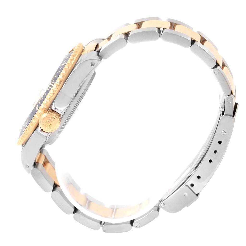 This side view of a Rolex Submariner 16613 Men's Steel and Gold (two tone) Champagne Dial 16613 Men's Steel and Gold (two tone) Champagne Dial shows the bracelet, crown, and case with a two-tone design.