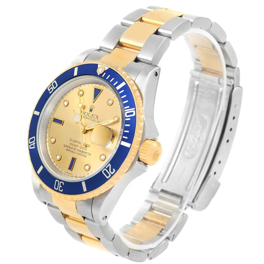 The image shows a Rolex Submariner 16613 Men's Steel and Gold (two tone) Champagne Dial 16613 Men's Steel and Gold (two tone) Champagne Dial watch at a three-quarter angle, highlighting its gold and silver band, bezel, and face.