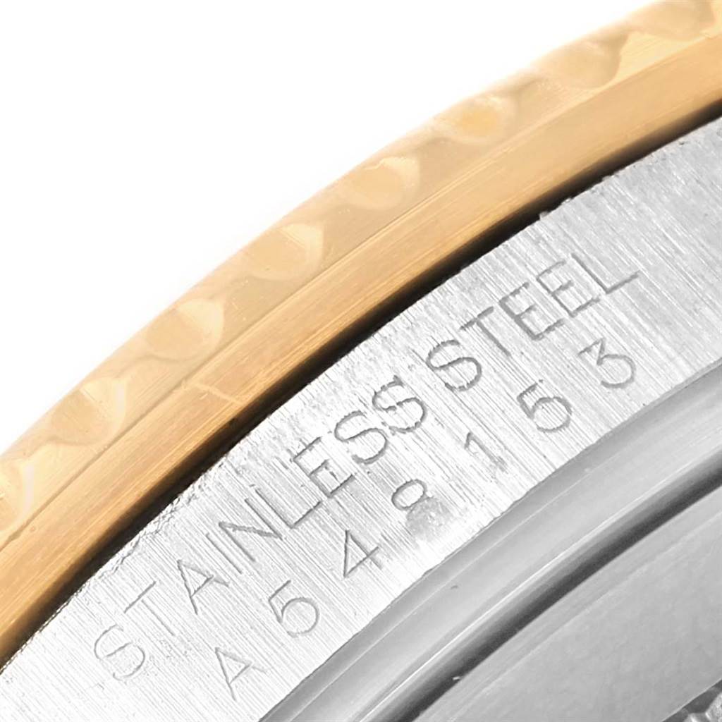 This image shows a close-up of the Rolex Submariner 16613 Men's Steel and Gold (two tone) Champagne Dial 16613 Men's Steel and Gold (two tone) Champagne Dial's bezel edge and engraved stainless steel case.