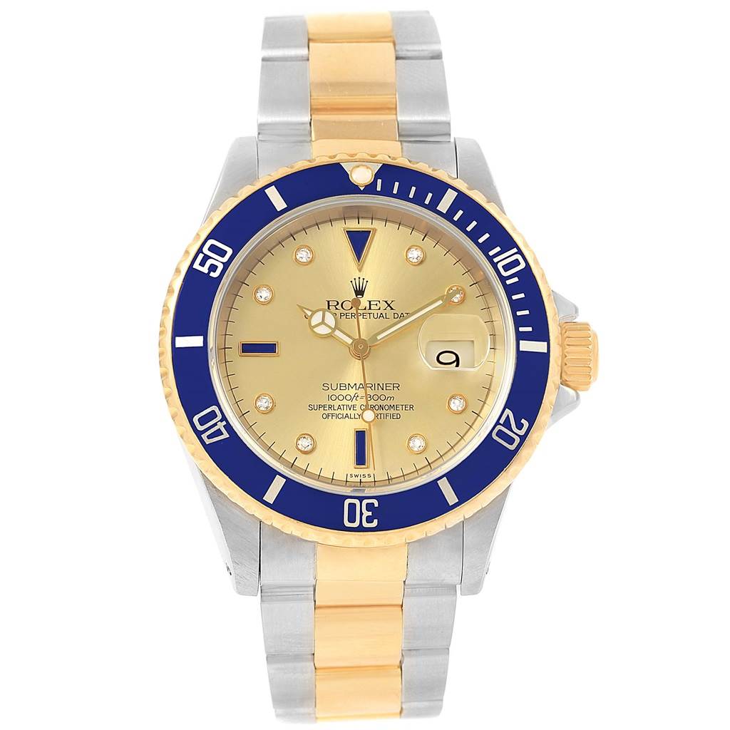 The image shows a front view of a Rolex Submariner 16613 Men's Steel and Gold (two tone) Champagne Dial 16613 Men's Steel and Gold (two tone) Champagne Dial watch with a blue and gold bezel and a two-tone metal bracelet.
