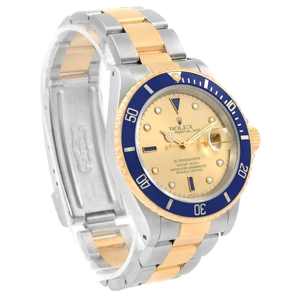 The image shows a Rolex Submariner 16613 Men's Steel and Gold (two tone) Champagne Dial 16613 Men's Steel and Gold (two tone) Champagne Dial watch at a slight angle, highlighting its two-tone metal bracelet, blue bezel, and gold dial.