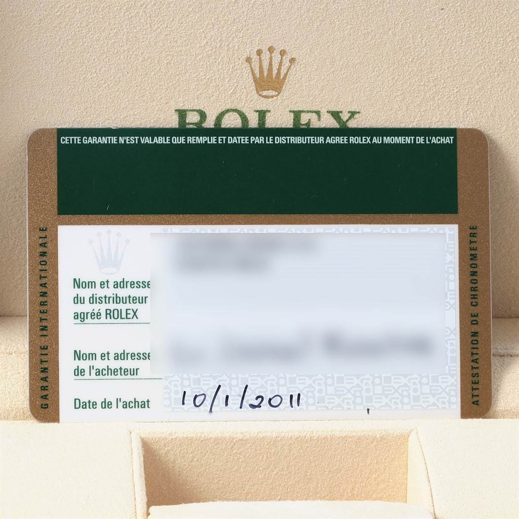 The image shows a Rolex warranty card for the Submariner model, with the brand logo and purchase date visible.