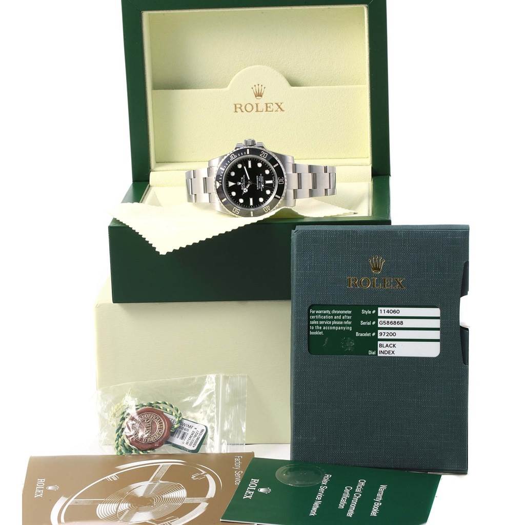 The image shows a Rolex Submariner 114060 Men's Stainless Steel Black Dial 114060 Men's Stainless Steel Black Dial watch in its open box, along with accompanying documents and tags.