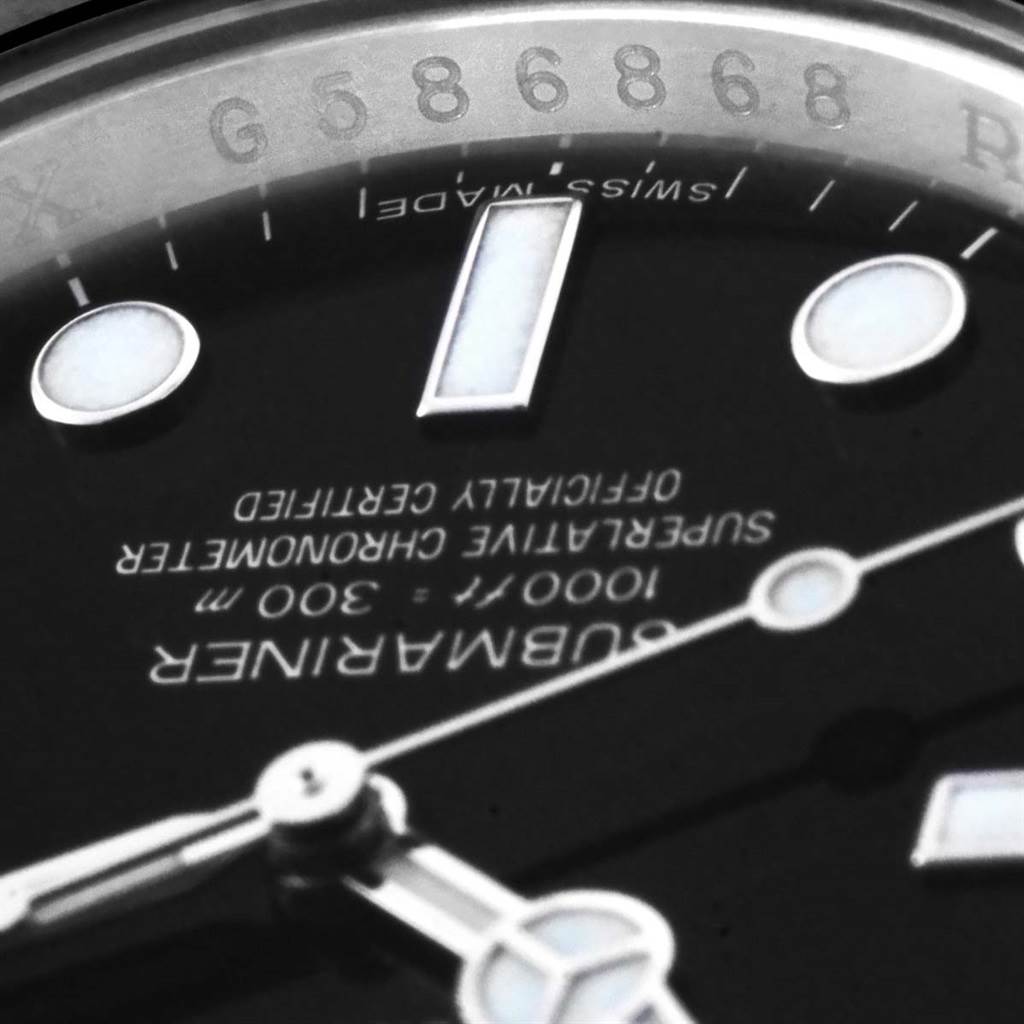This close-up shot of the Rolex Submariner 114060 Men's Stainless Steel Black Dial 114060 Men's Stainless Steel Black Dial watch shows the dial, hands, and part of the inscription.