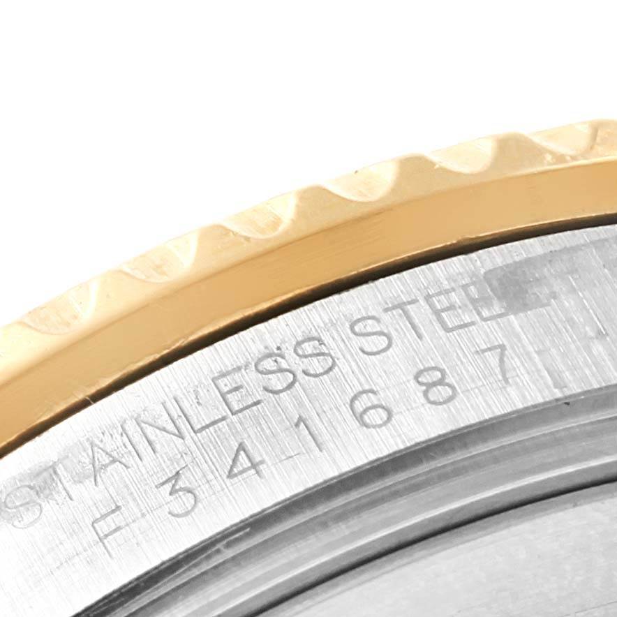 The image shows a close-up of the bezel and case back of the Rolex Submariner 16613 Men
s Steel and Gold (two tone) Black Dial 16613 Men
s Steel and Gold (two tone) Black Dial, highlighting stainless steel details.