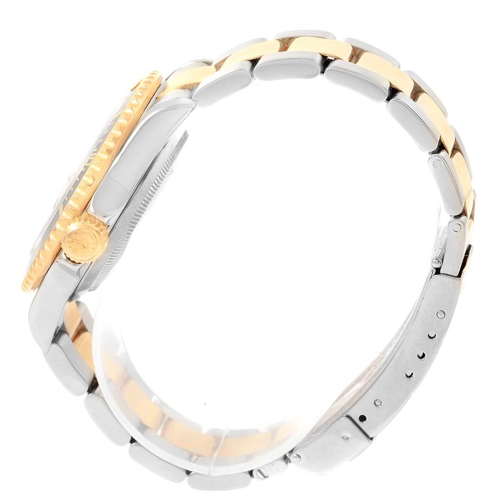 The image shows a side view of a Rolex Submariner 16613 Men
s Steel and Gold (two tone) Black Dial 16613 Men
s Steel and Gold (two tone) Black Dial watch, highlighting the crown, bezel, and two-tone metal bracelet.