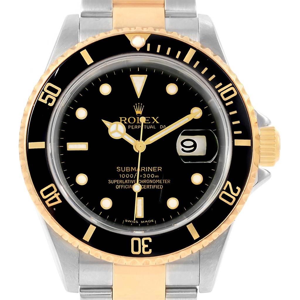 This image shows the face and bezel of a Rolex Submariner 16613 Men
s Steel and Gold (two tone) Black Dial 16613 Men
s Steel and Gold (two tone) Black Dial watch, with a two-tone band, black dial, and date window.