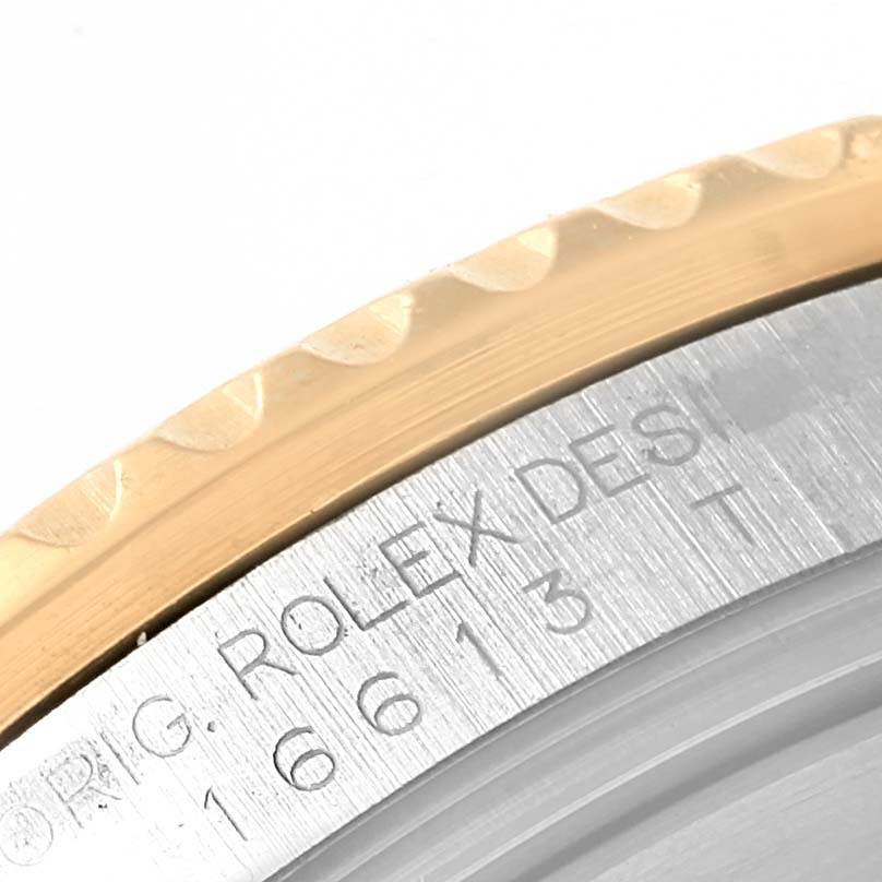 This close-up image shows the engraved bezel and case of a Rolex Submariner 16613 Men
s Steel and Gold (two tone) Black Dial 16613 Men
s Steel and Gold (two tone) Black Dial.