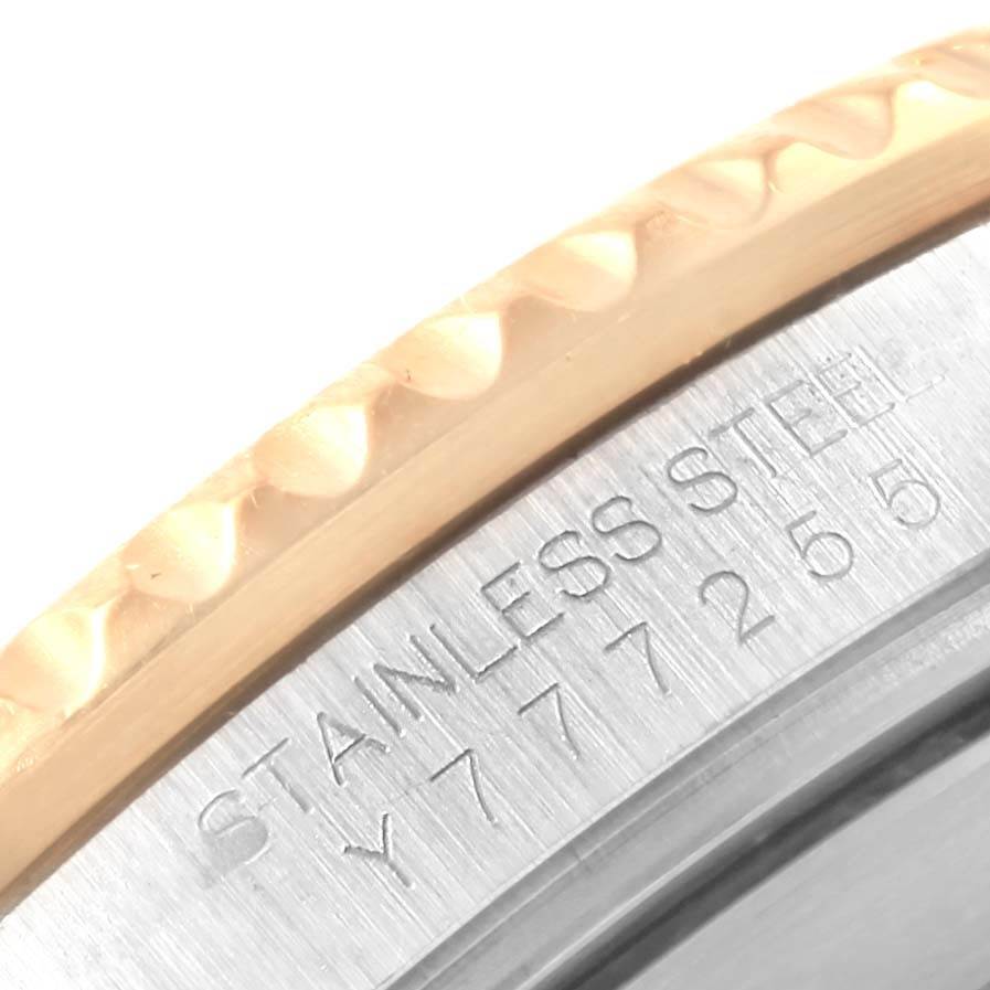 This close-up image of the Rolex Submariner 16613 Men's Steel and Gold (two tone) Blue Dial 16613 Men's Steel and Gold (two tone) Blue Dial watch shows part of the bezel and the engraved serial number.