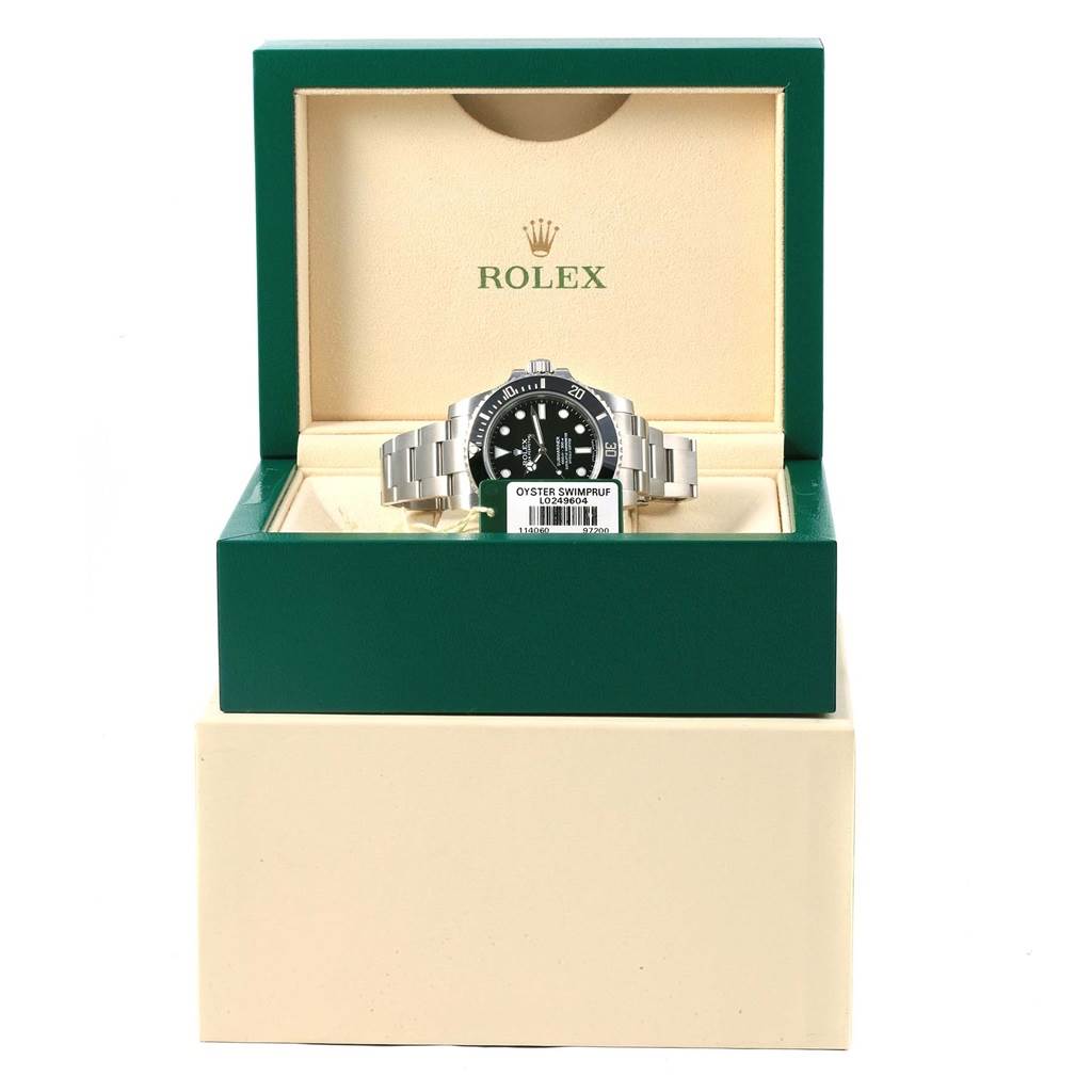 The image shows a Rolex Submariner 114060 Men's Stainless Steel Black Dial 114060 Men's Stainless Steel Black Dial watch in its green and beige box, viewed from the front.