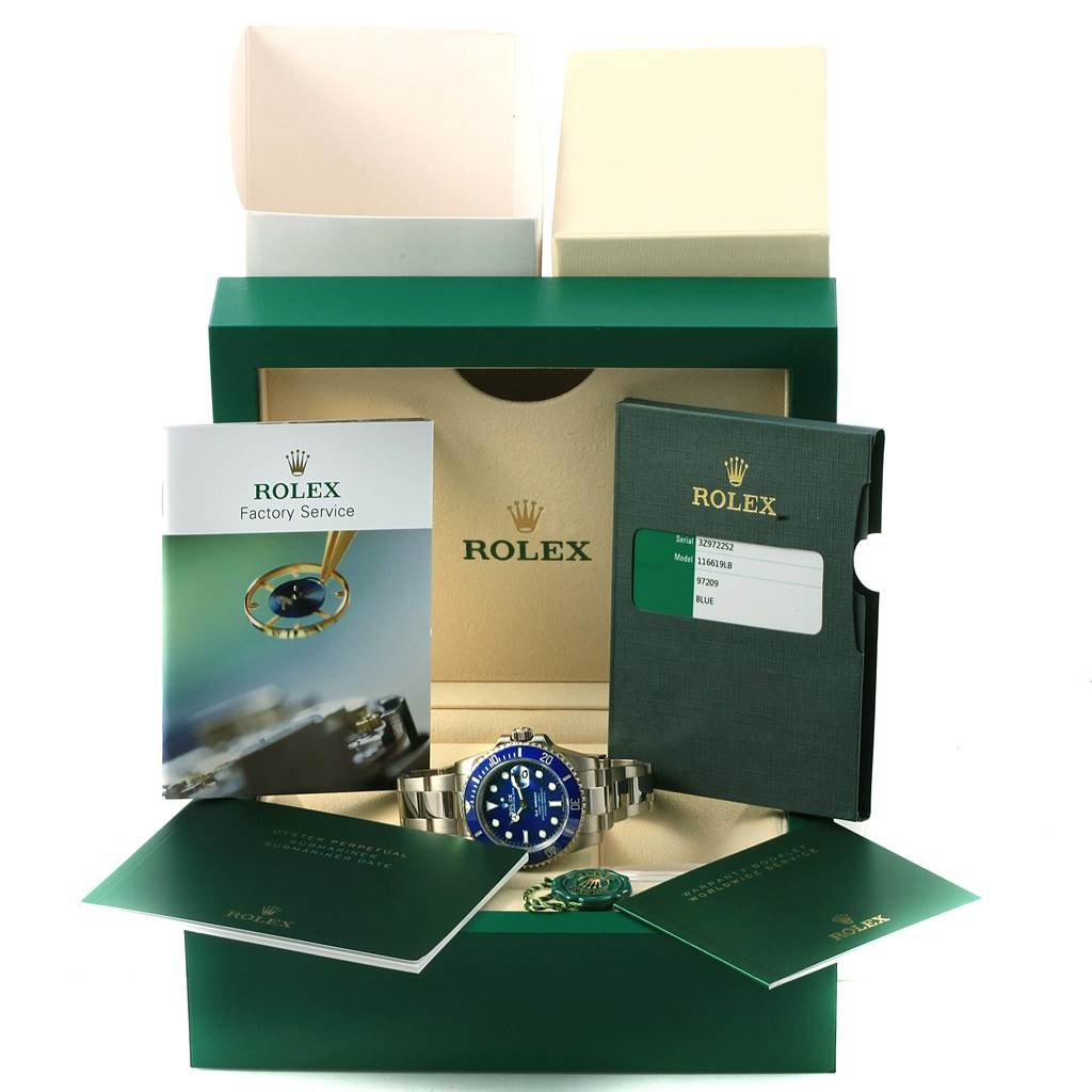The image shows a Rolex Submariner 116619 Men's White Gold Blue Dial 116619 Men's White Gold Blue Dial watch in its box, along with manuals, warranty card, and the official packaging.