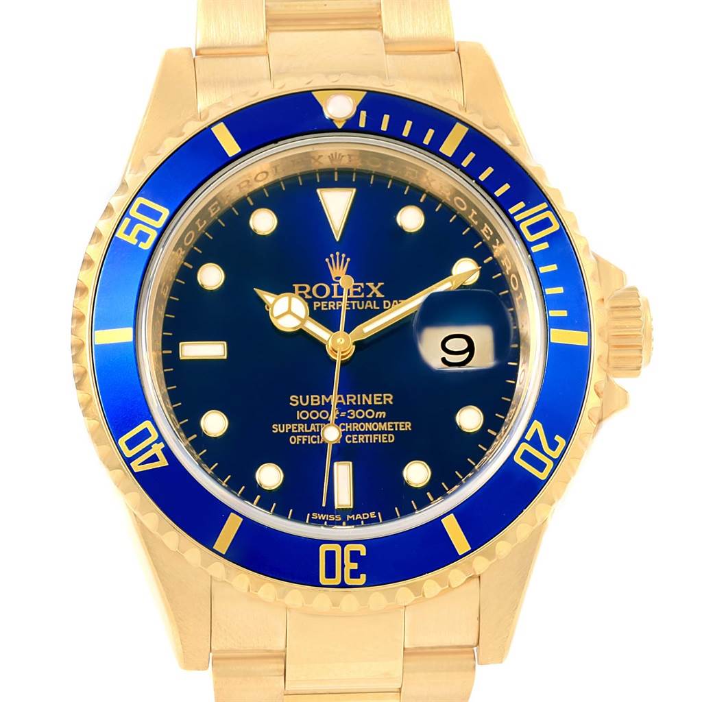 The image shows a front view of a Rolex Submariner 16618 Men's Yellow Gold Blue Dial 16618 Men's Yellow Gold Blue Dial with a gold band, blue bezel, and blue dial featuring a date display at 3 o'clock.
