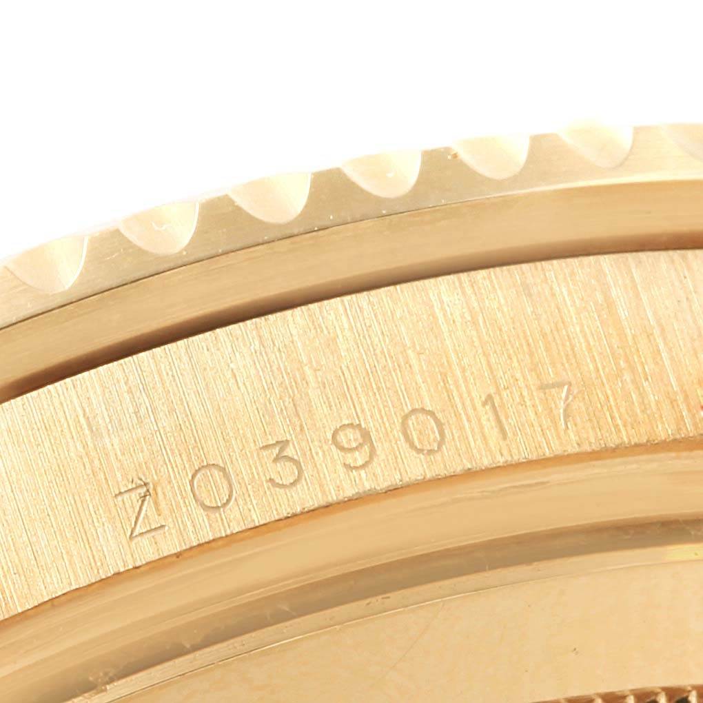 The image shows a close-up of the bezel and serialized edge of the Rolex Submariner 16618 Men's Yellow Gold Blue Dial 16618 Men's Yellow Gold Blue Dial model watch.