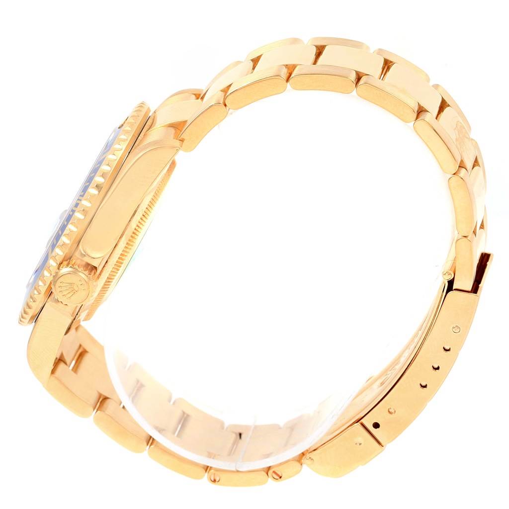 The image shows the side view of a Rolex Submariner 16618 Men's Yellow Gold Blue Dial 16618 Men's Yellow Gold Blue Dial watch, featuring its gold case, crown, and bracelet.