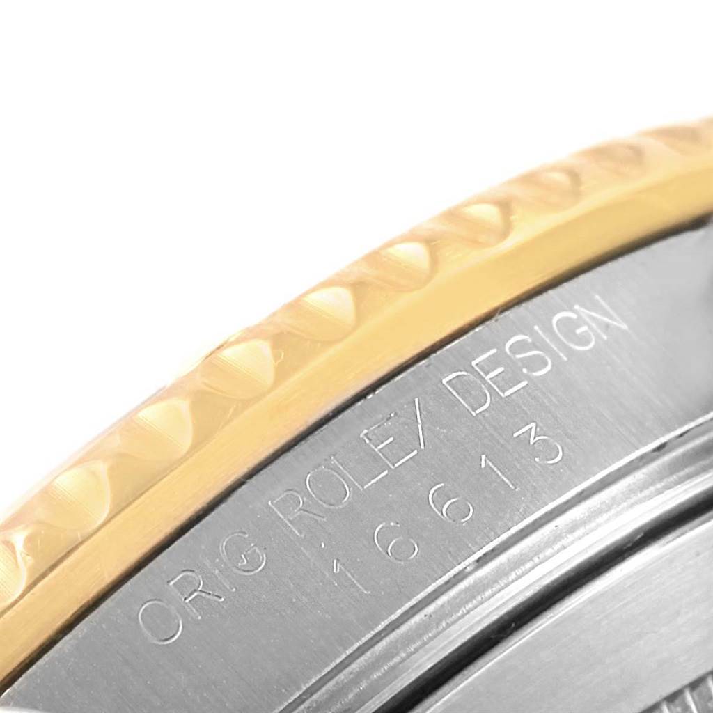 The image shows a close-up of the case side engraving and the bezel of a Rolex Submariner 16613 Men
s Steel and Gold (two tone) Purple Dial 16613 Men
s Steel and Gold (two tone) Purple Dial watch.