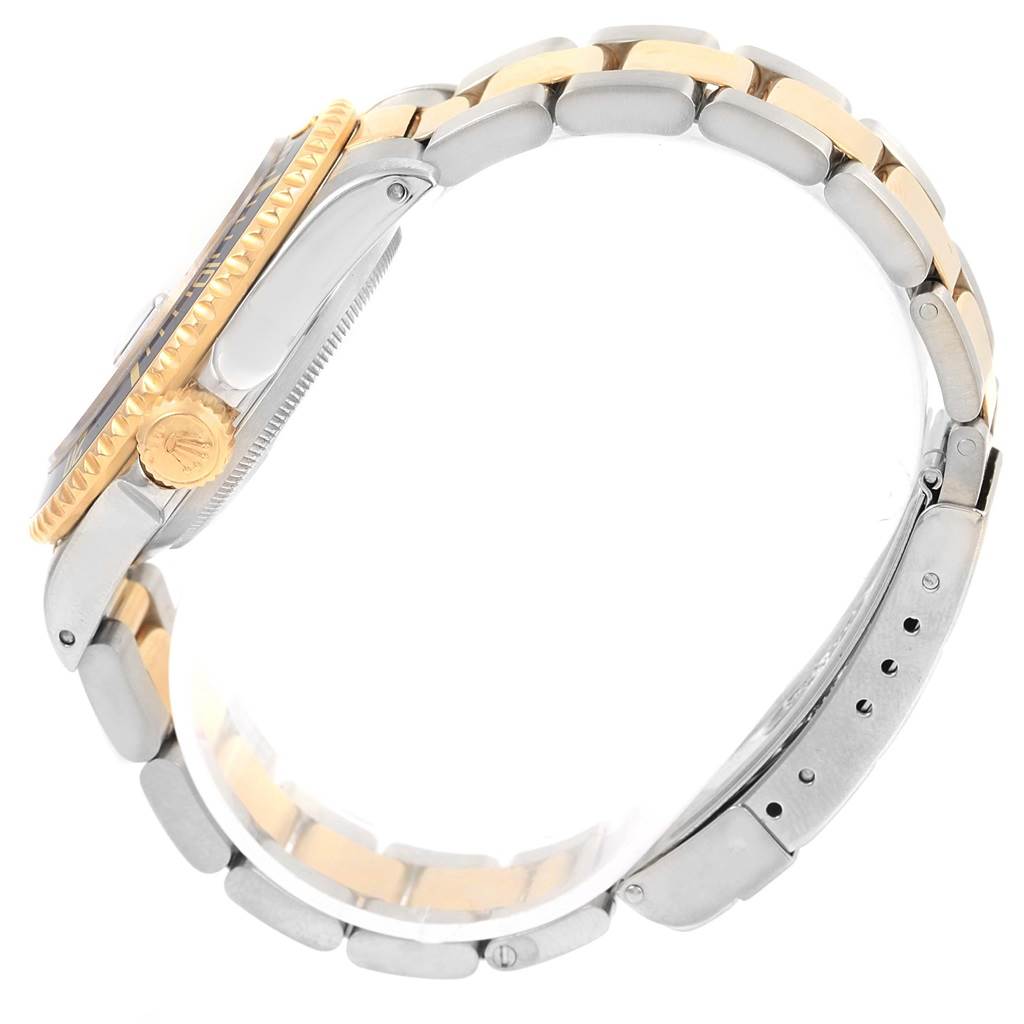 The image shows a side profile of a Rolex Submariner 16613 Men
s Steel and Gold (two tone) Purple Dial 16613 Men
s Steel and Gold (two tone) Purple Dial watch, highlighting its crown, bezel, and two-tone bracelet.