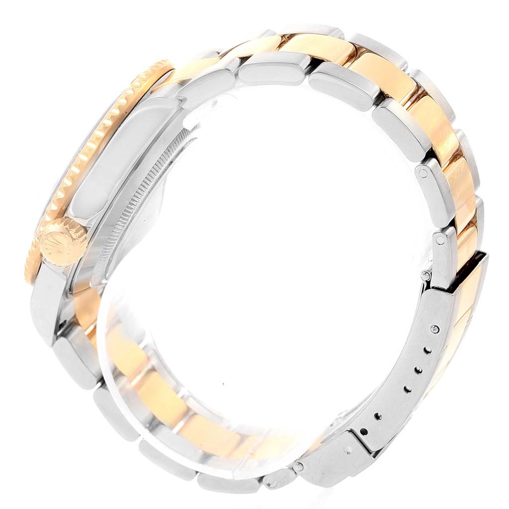 This image shows the side view of a Rolex Submariner 16613 Men's Steel and Gold (two tone) Blue Dial 16613 Men's Steel and Gold (two tone) Blue Dial watch, highlighting its two-tone bracelet and crown.