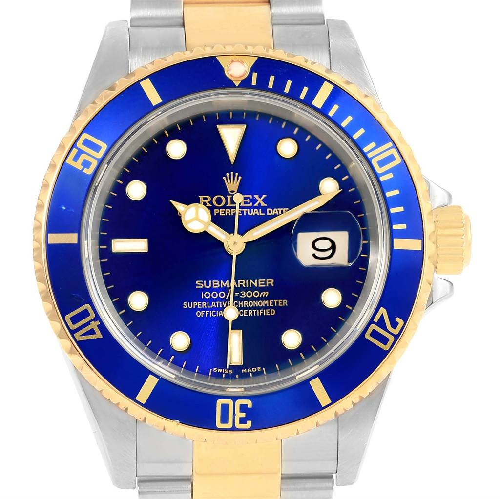 The image shows the face of the Rolex Submariner 16613 Men's Steel and Gold (two tone) Blue Dial 16613 Men's Steel and Gold (two tone) Blue Dial watch, displaying the bezel, dial, hands, and date window.