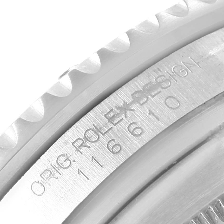 The image shows a close-up of the engraved text and the bezel edge of a Rolex Submariner 116610 Men's Stainless Steel Black Dial 116610 Men's Stainless Steel Black Dial watch.