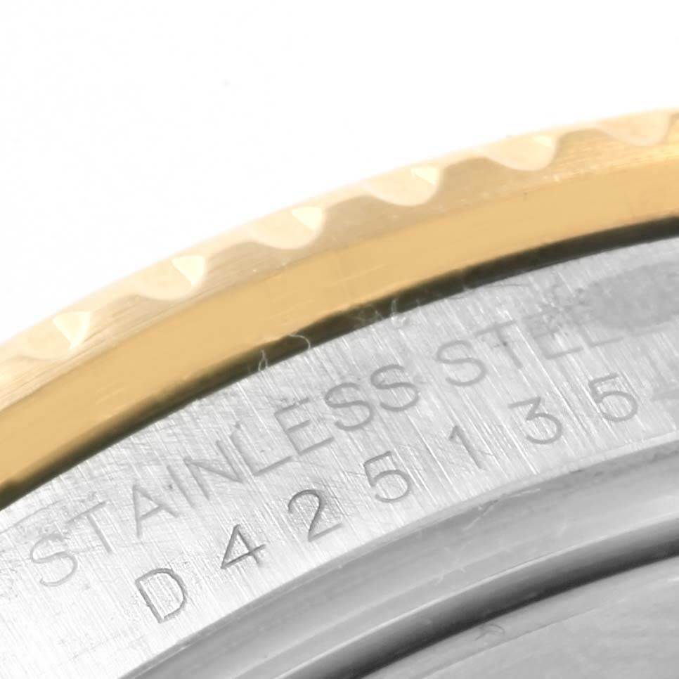 This close-up image shows the engraved stainless steel back and part of the gold bezel of a Rolex Submariner 16613 Men's Steel and Gold (two tone) Champagne Dial 16613 Men's Steel and Gold (two tone) Champagne Dial watch.