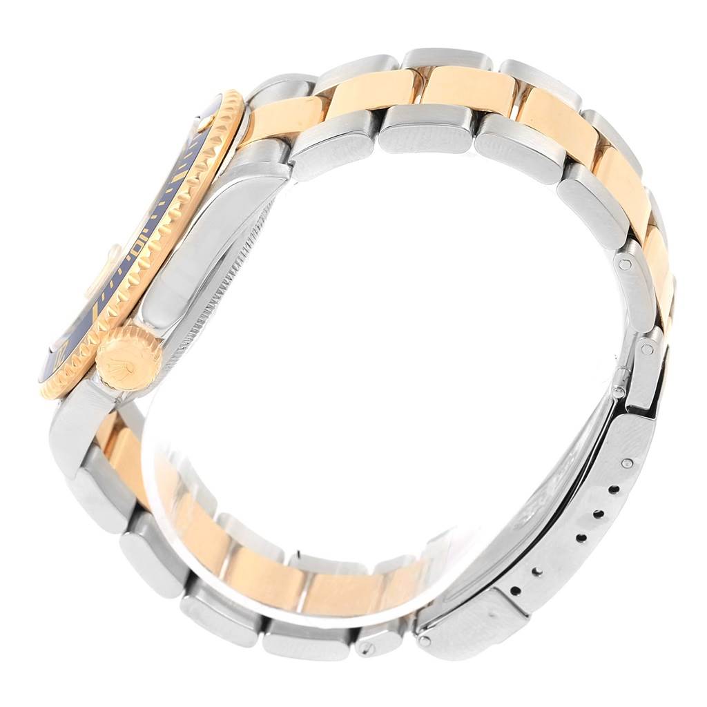 This side view image of the Rolex Submariner 16613 Men's Steel and Gold (two tone) Champagne Dial 16613 Men's Steel and Gold (two tone) Champagne Dial shows the crown, bezel, and two-tone bracelet.