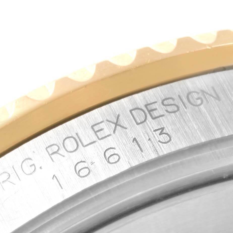 This image shows a close-up of the engraved model number and part of the bezel of a Rolex Submariner 16613 Men's Steel and Gold (two tone) Blue Dial 16613 Men's Steel and Gold (two tone) Blue Dial watch.