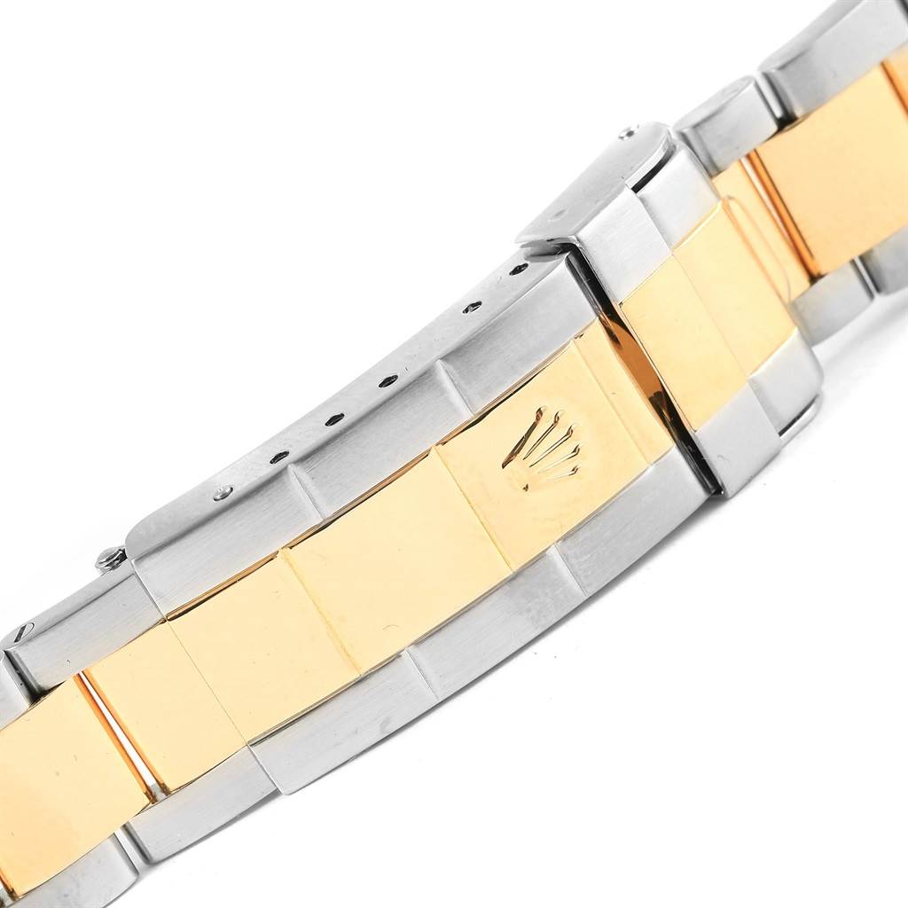 This image shows a close-up view of the two-tone bracelet and clasp of a Rolex Submariner 16613 Men's Steel and Gold (two tone) Blue Dial 16613 Men's Steel and Gold (two tone) Blue Dial watch.
