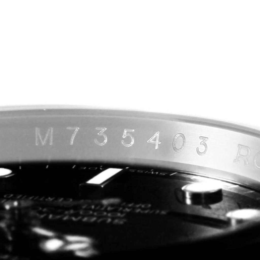 The image shows a close-up angle of the serial number engraved on the inner bezel ring of a Rolex Submariner 16610 Men's Stainless Steel Black Dial 16610 Men's Stainless Steel Black Dial.
