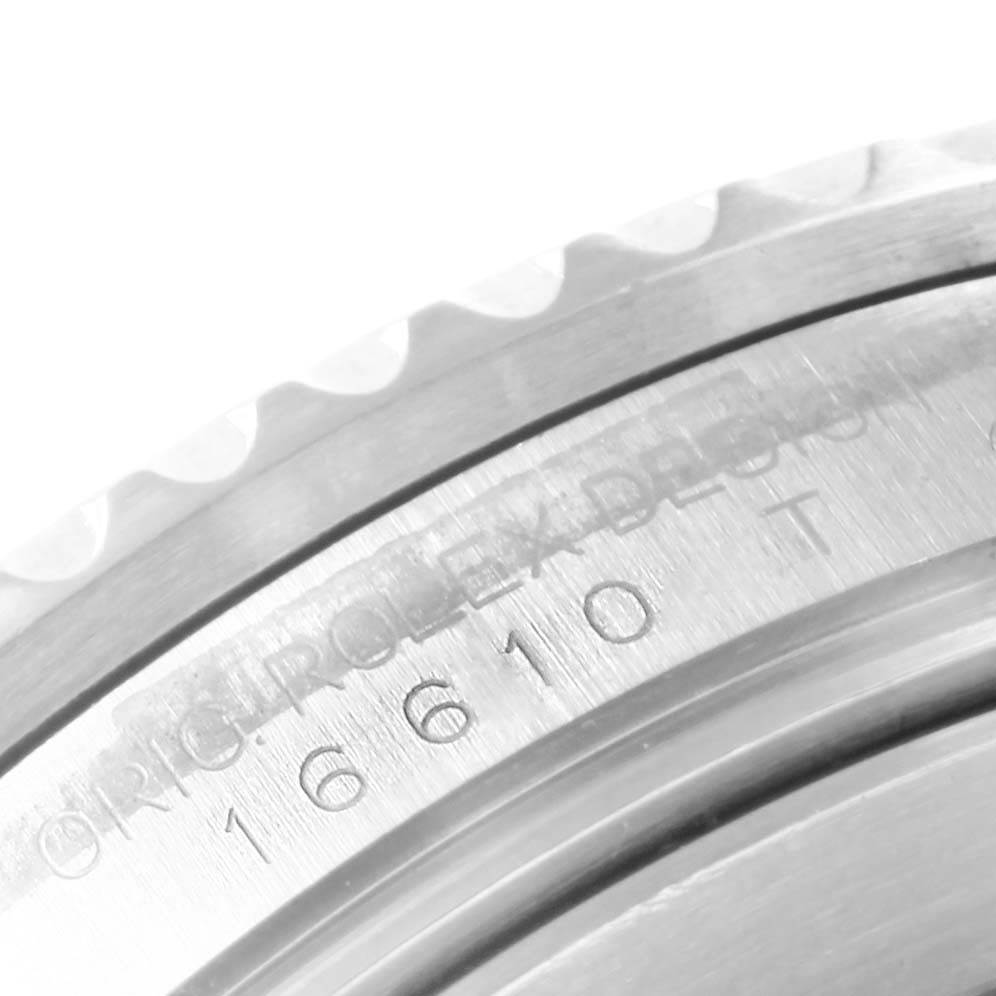 The image shows a close-up of the serial number and part of the bezel of a Rolex Submariner 16610 Men's Stainless Steel Black Dial 16610 Men's Stainless Steel Black Dial watch.