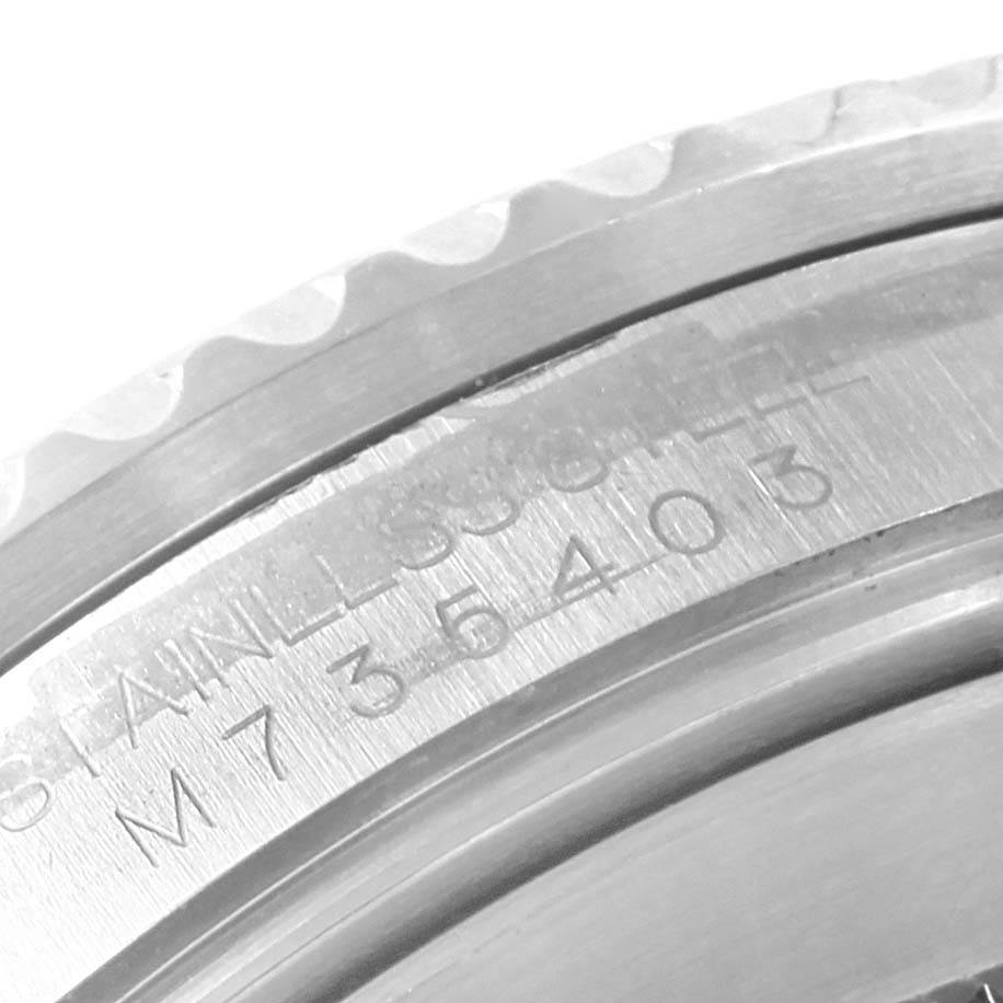 This close-up image shows the engraved serial number and stainless steel marking on the Rolex Submariner 16610 Men's Stainless Steel Black Dial 16610 Men's Stainless Steel Black Dial watch bezel.