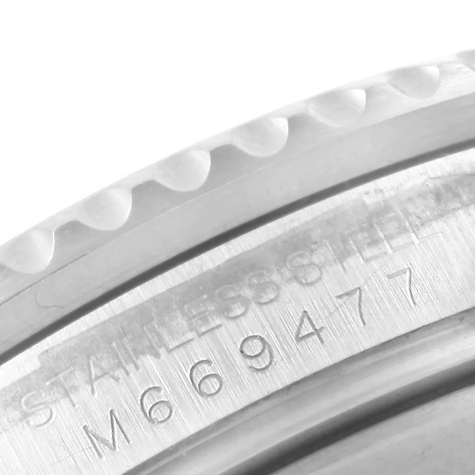The image shows a close-up angled view of the bezel and engraved serial number on a Rolex Submariner 16610 Men's Stainless Steel Black Dial 16610 Men's Stainless Steel Black Dial watch, emphasizing its stainless steel material.