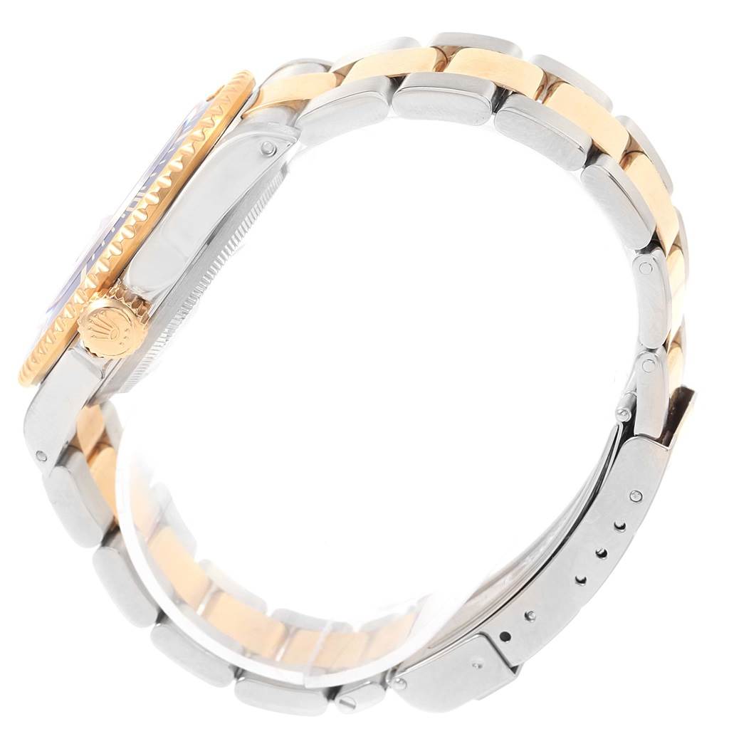 The image shows a side view of a Rolex Submariner 16613 Men's Steel and Gold (two tone) Blue Dial 16613 Men's Steel and Gold (two tone) Blue Dial watch, highlighting its crown, case, and two-tone bracelet.