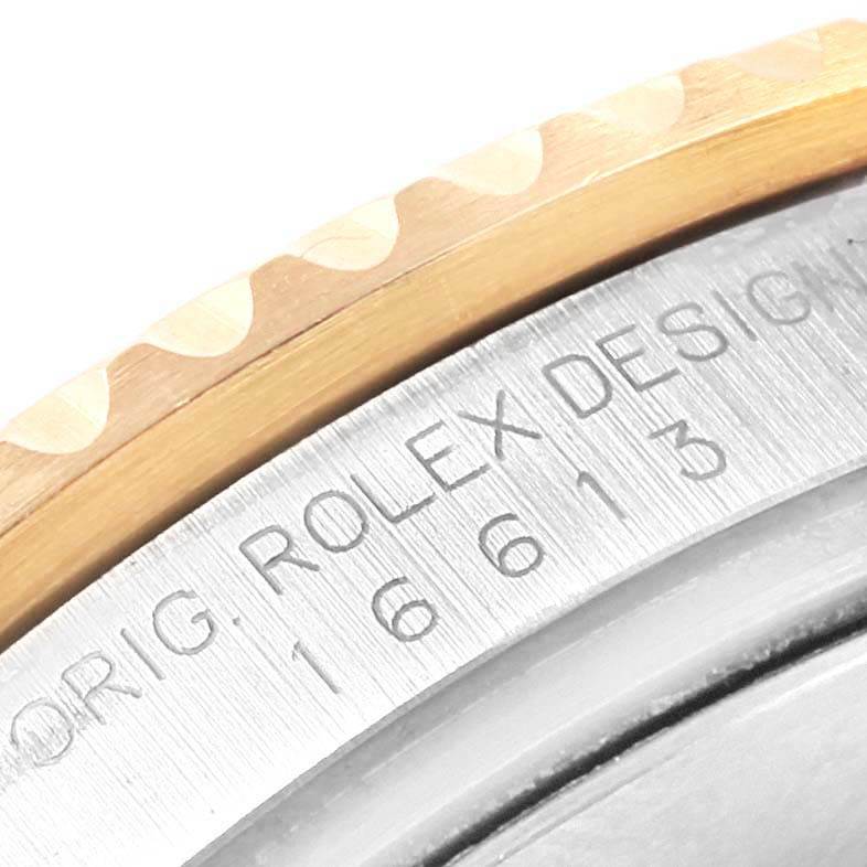 This image shows a close-up of the bezel and engraved markings on the side of a Rolex Submariner 16613 Men's Steel and Gold (two tone) Blue Dial 16613 Men's Steel and Gold (two tone) Blue Dial watch.
