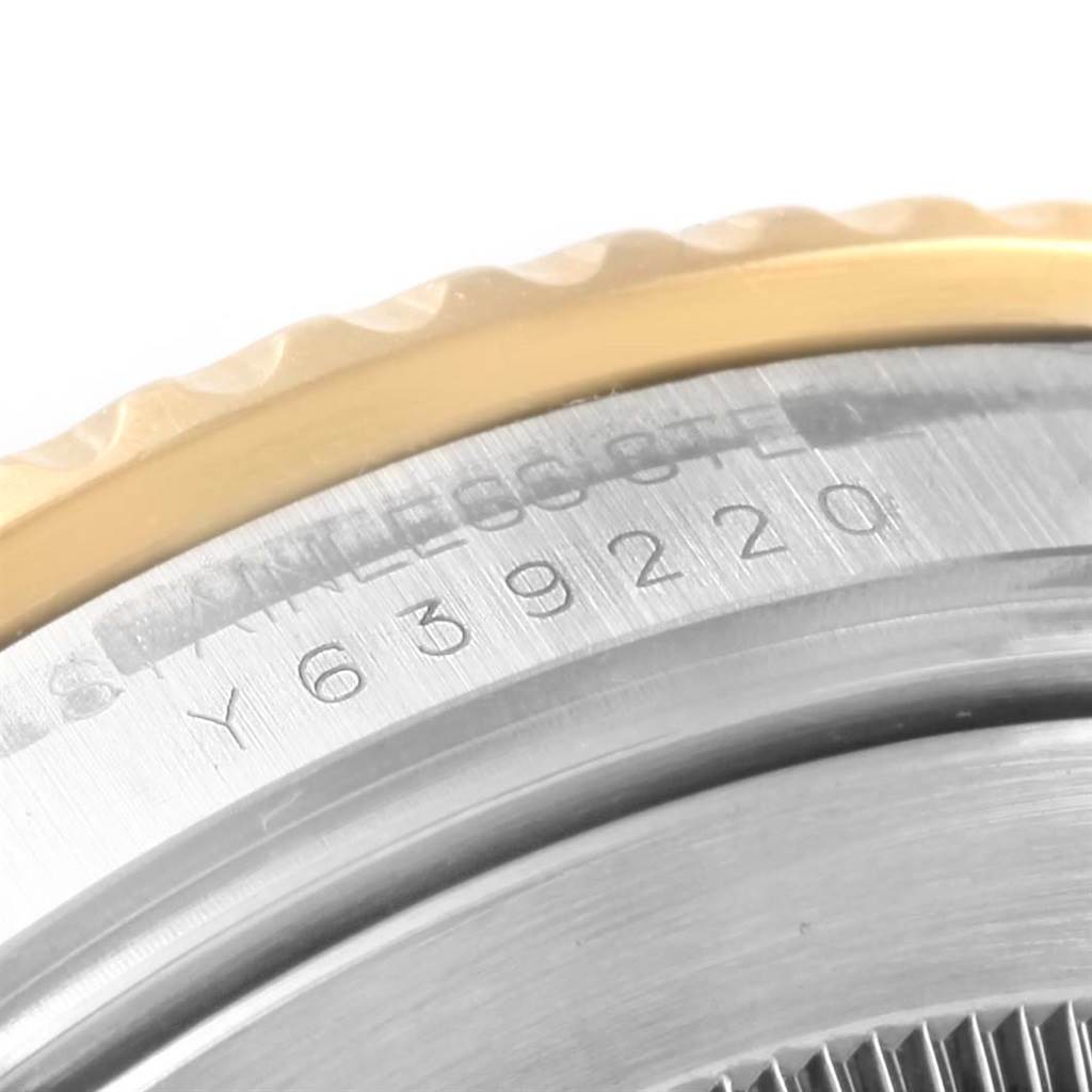 This close-up image shows the edge of the bezel and part of the case with the serial number engraving on a Rolex Submariner 16613 Men's Steel and Gold (two tone) Blue Dial 16613 Men's Steel and Gold (two tone) Blue Dial watch.