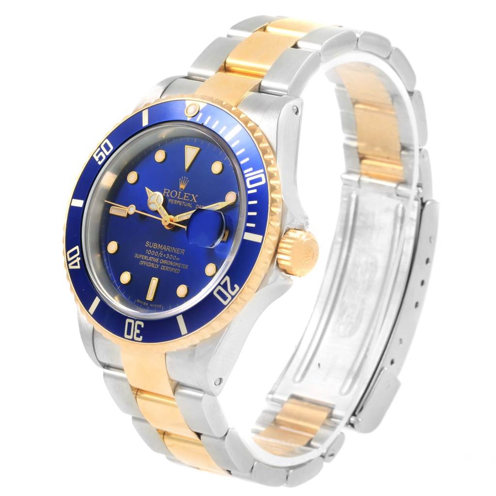 This Rolex Submariner 16613 Men's Steel and Gold (two tone) Blue Dial 16613 Men's Steel and Gold (two tone) Blue Dial watch is shown at a 3/4 angle featuring its blue dial, two-tone metal band, and bezel.