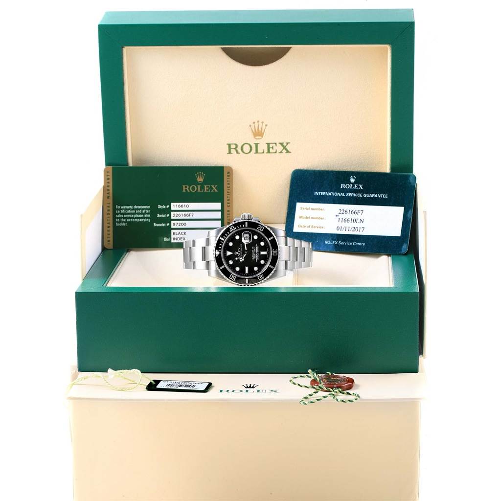 The image shows a front view of the Rolex Submariner 116610 Men's Stainless Steel Black Dial 116610 Men's Stainless Steel Black Dial watch, nestled in its box, along with warranty and service cards.