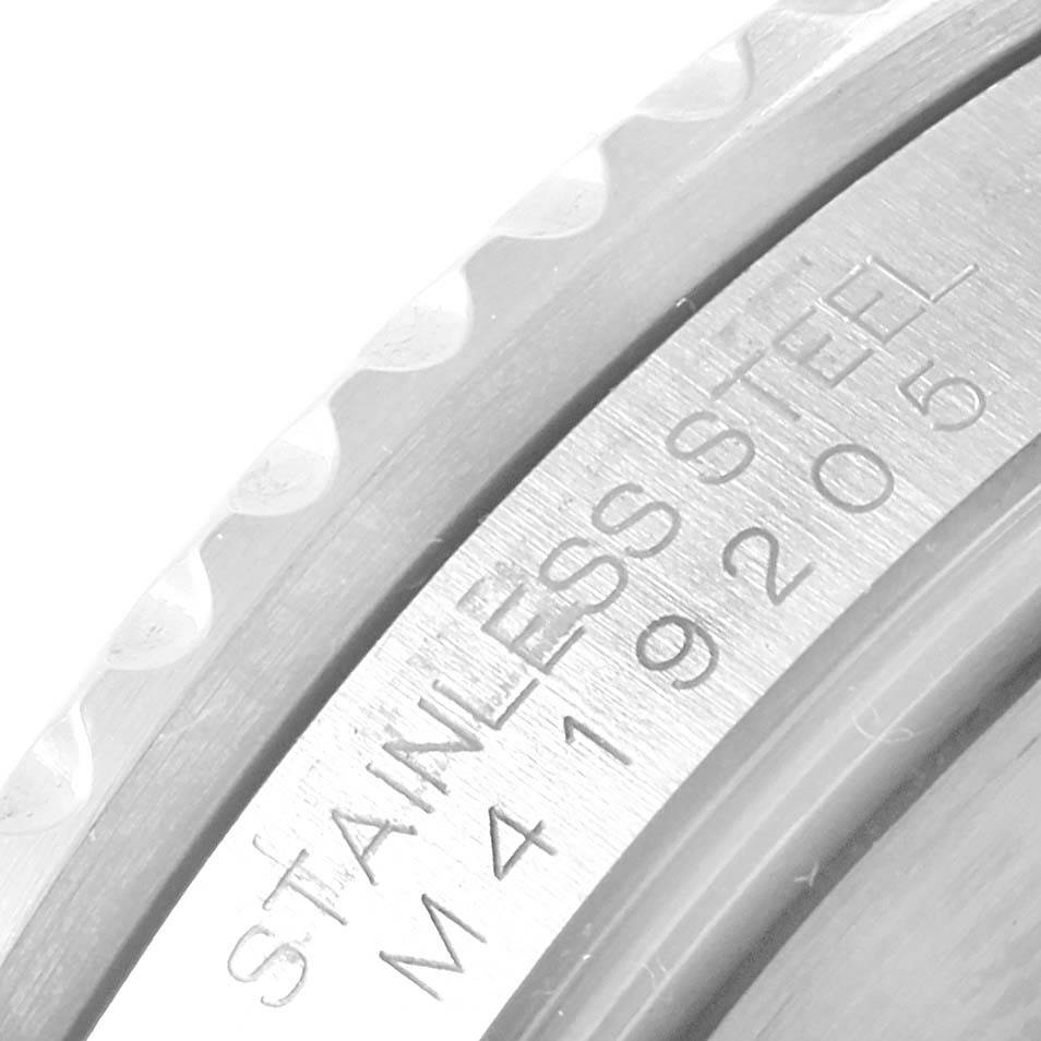 The image shows a close-up of the side engraving on a Rolex Submariner 16610 Men's Stainless Steel Black Dial 16610 Men's Stainless Steel Black Dial watch, detail focusing on the stainless steel marking and serial number.