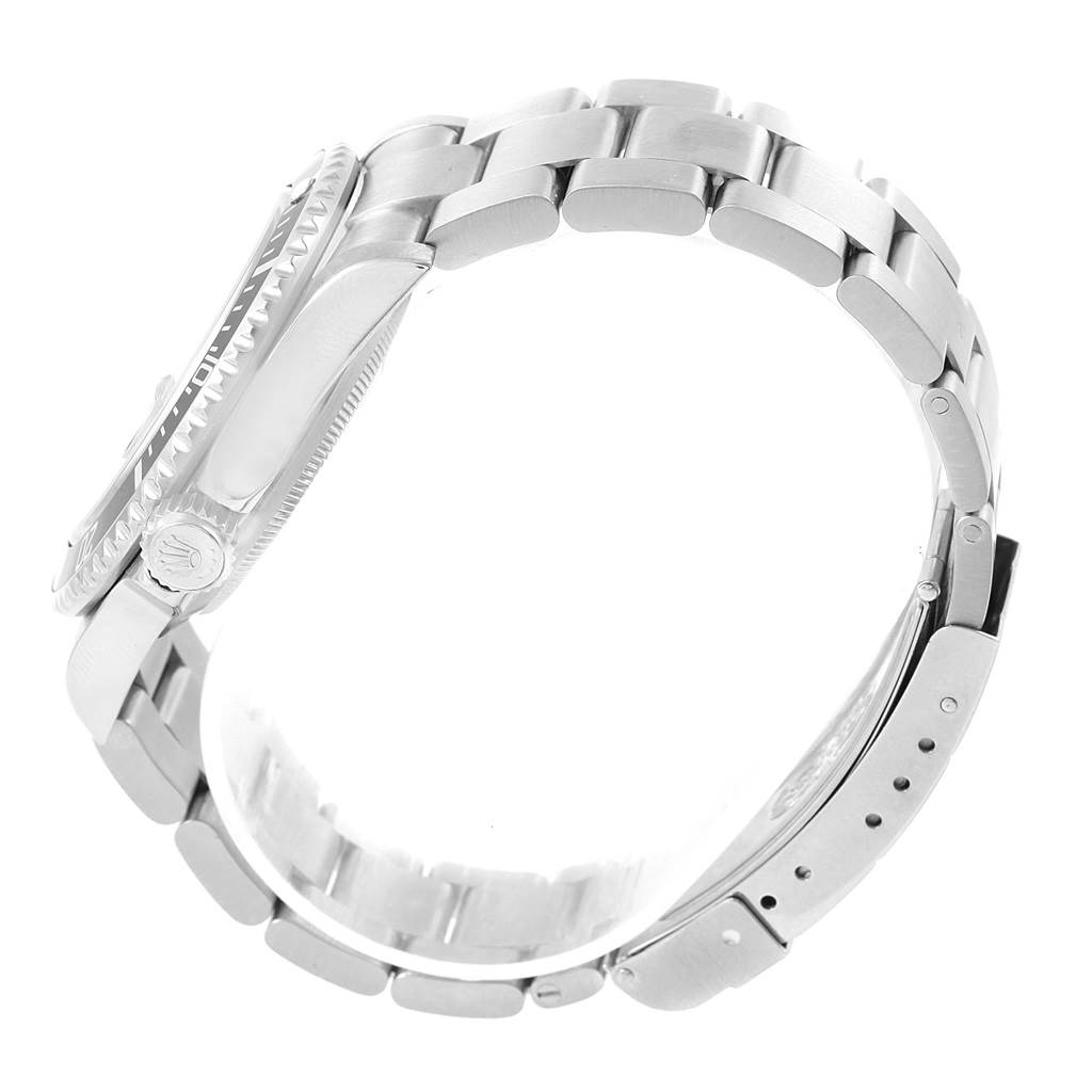 This side view of the Rolex Submariner 16610 Men's Stainless Steel Black Dial 16610 Men's Stainless Steel Black Dial shows the watch case, bezel, crown, and metal bracelet links.