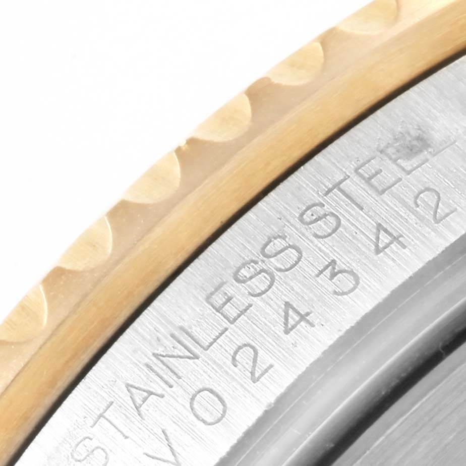 This close-up image of a Rolex Submariner 16613 Men's Steel and Gold (two tone) Blue Dial 16613 Men's Steel and Gold (two tone) Blue Dial watch shows part of the bezel and the engraved stainless steel case.