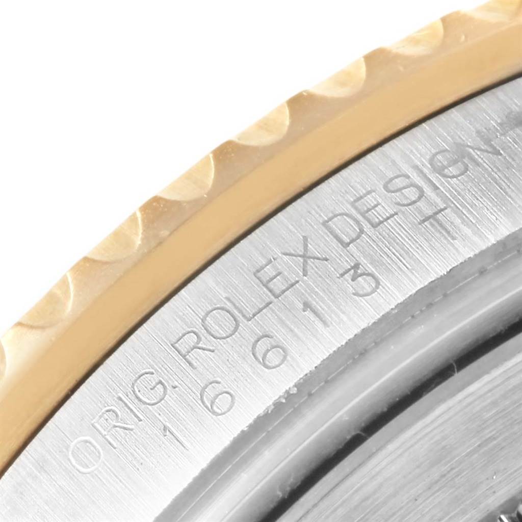 The image shows a close-up of the bezel and engraved case back of a Rolex Submariner 16613 Men's Steel and Gold (two tone) Blue Dial 16613 Men's Steel and Gold (two tone) Blue Dial watch.