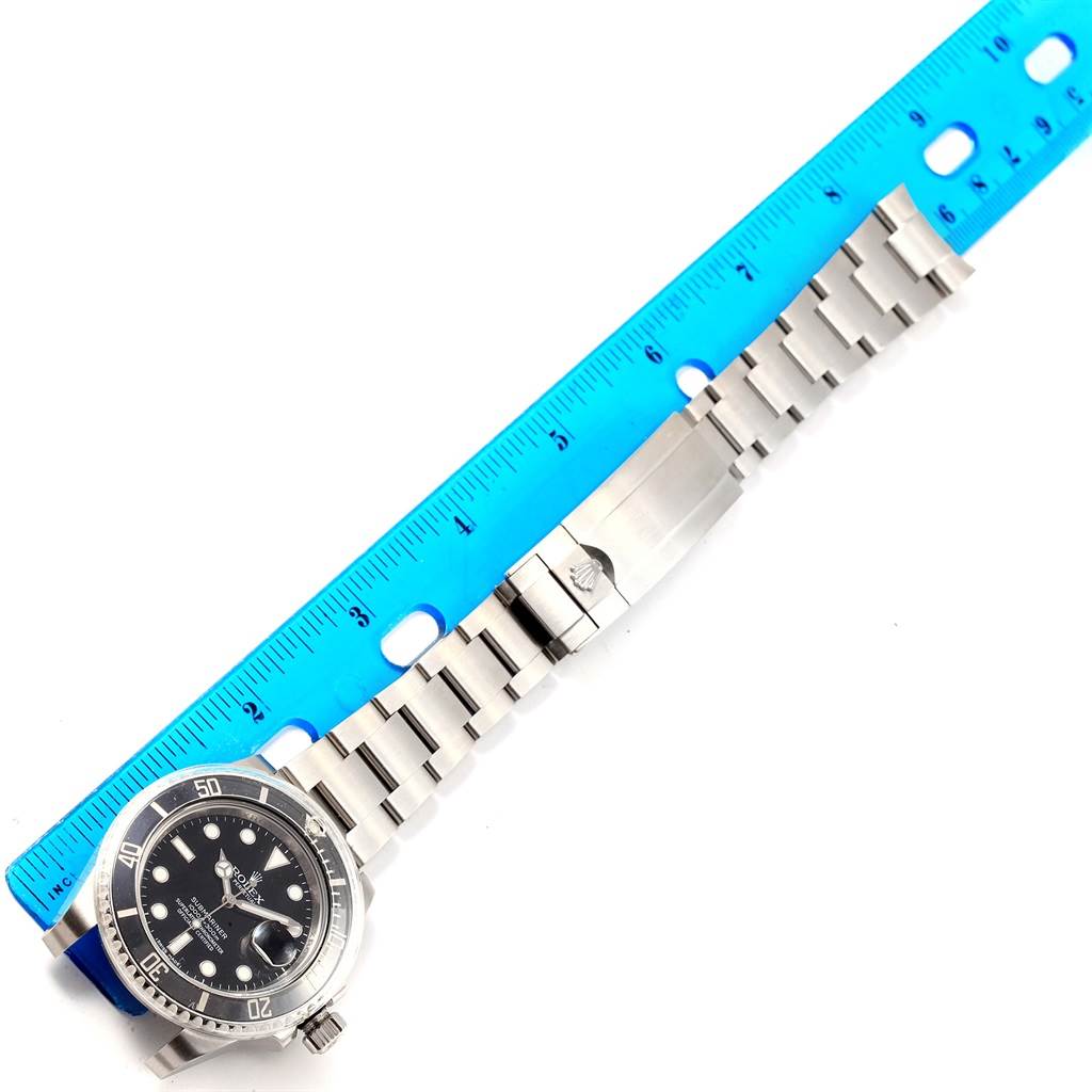 The image shows a Rolex Submariner 116610 Men's Stainless Steel Black Dial 116610 Men's Stainless Steel Black Dial watch, including the face, bezel, bracelet, and clasp, aligned next to a blue ruler.
